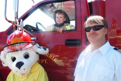 Sparky with three-year-old Christopher Perry and Fire Chief Casey Cuddy at Flinton's Touch a Truck event on June13.